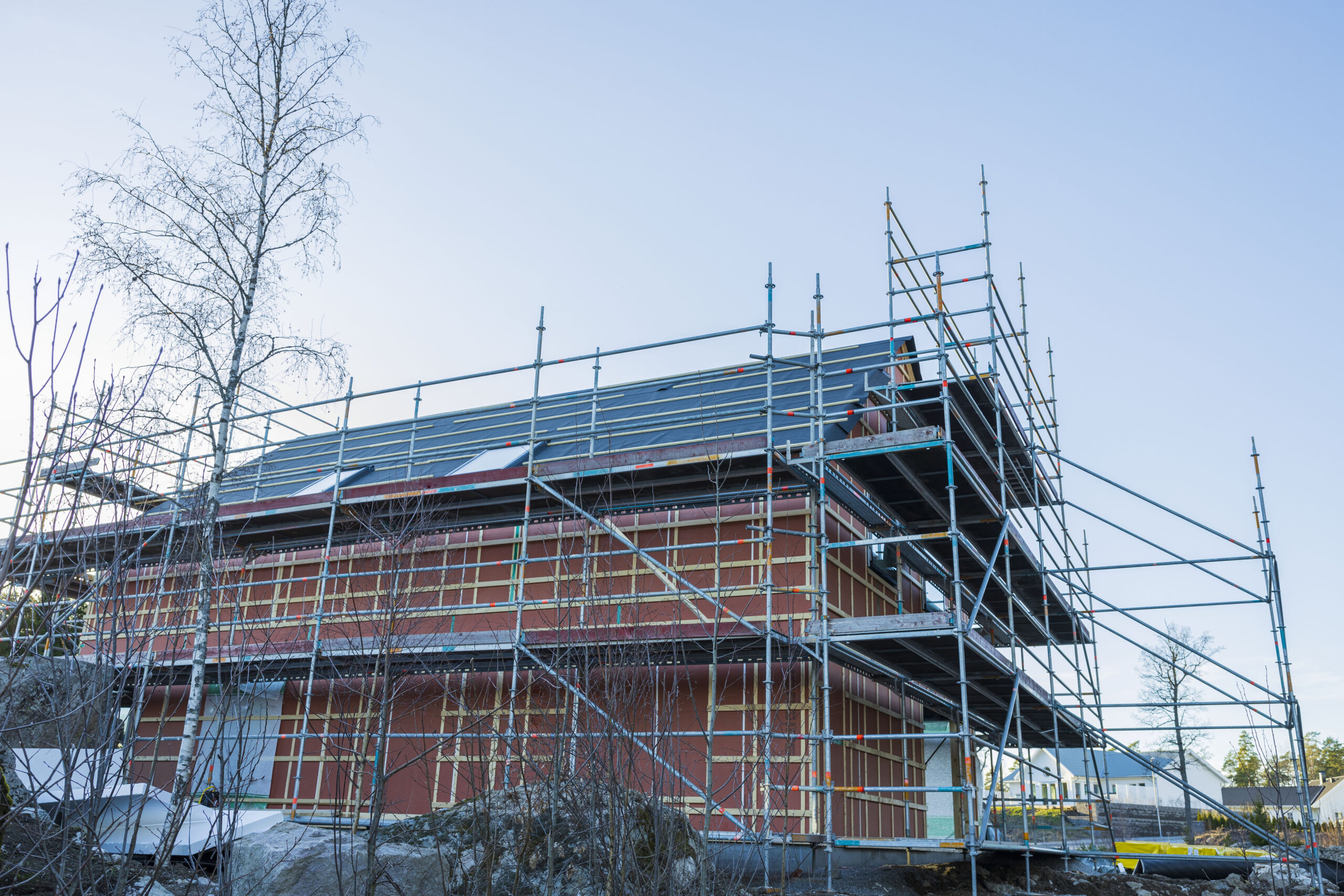 Close up view building under construction on blue sky background.